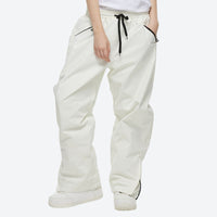 
                  
                    Unisex 2-layer snowboard jacket and pants - white snow pants, on-model three-quarter front view, for resort and street wear
                  
                