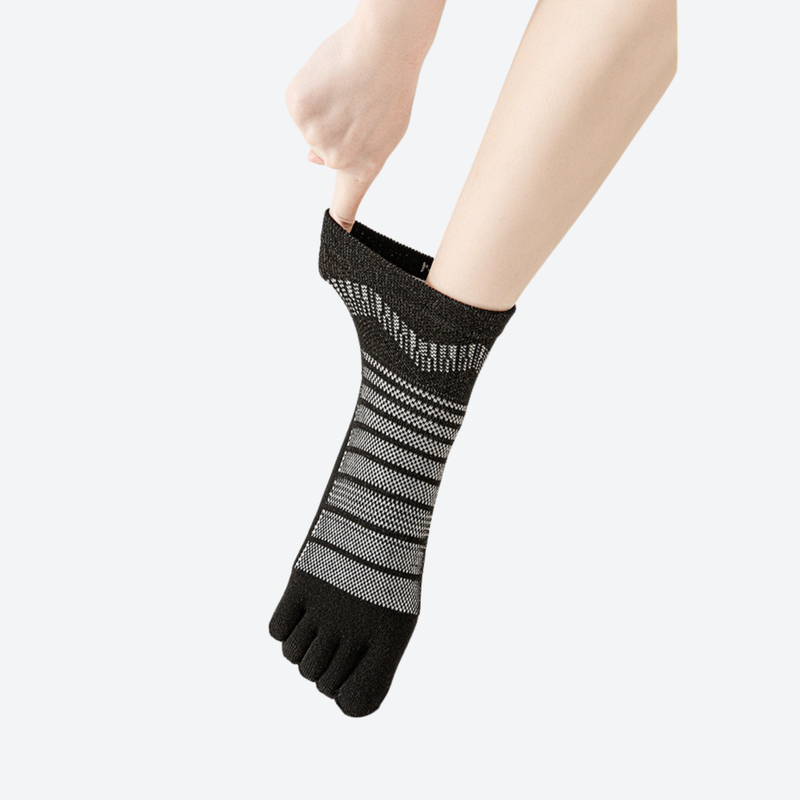 Merino wool toe socks for blister-free miles - black five-toe merino wool socks on feet, hand pulling close-up