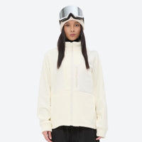 
                  
                    Breathable quick-dry fleece liner for layering - cream fleece liner jacket on women with goggles, front standing view
                  
                