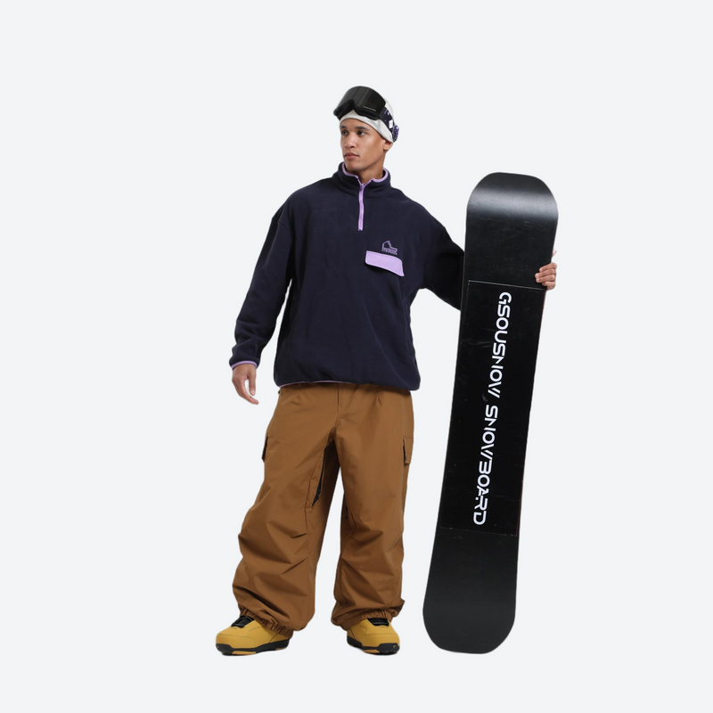3-layer snowboard cargo pants - tan snow pants, on-model front with upright snowboard, for powder days and winter commute