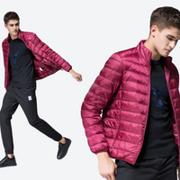 
                  
                    Men's packable windproof down jacket with stuff sack - magenta ultra-light down jacket on men, walking view with front inset
                  
                