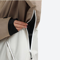 
                  
                    Women's colorblock ski jacket set - tan and cream, front zip close-up with hand, for resort and street wear
                  
                
