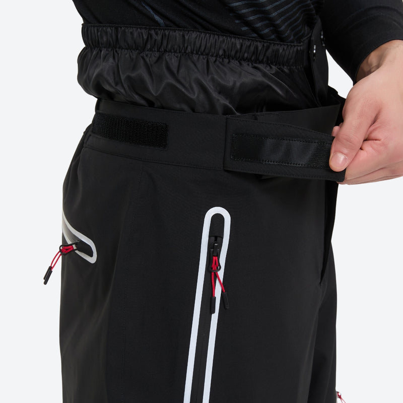 Men's 2-layer snowboard jacket and pants - black snow pants, waist strap close-up with hand, for resort and backcountry days