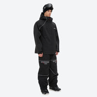 
                  
                    Men's 2-layer snowboard jacket and pants - black jacket with black pants, on-model side view, for resort and backcountry days
                  
                
