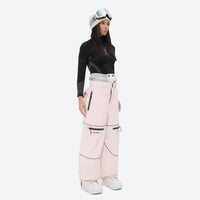 
                  
                    Women's 2-layer snowboard jacket and pants - pink snow pants with black top, on-model side view, for skiing and snowboarding
                  
                