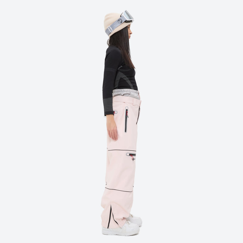 Women's waterproof 2L snow jacket and pants - pink snow pants with black top, on-model side view, for resort and street wear
