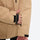 Men's breathable ski jacket with flap pockets - tan jacket, cuff strap close-up with hand, for cold-weather winter sports