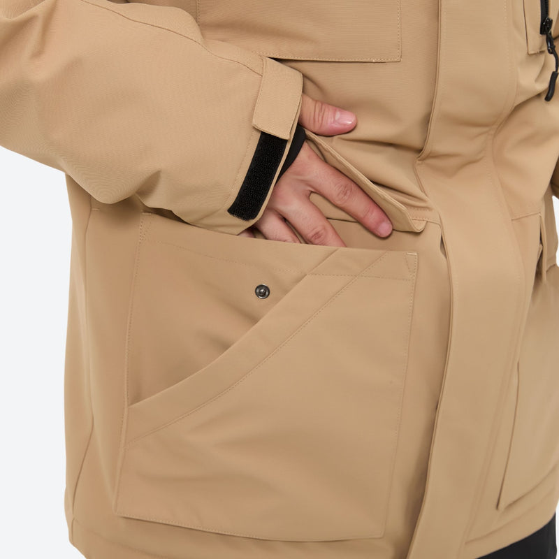 Men's breathable ski jacket with flap pockets - tan jacket, side pocket close-up with hand, for powder and piste riding