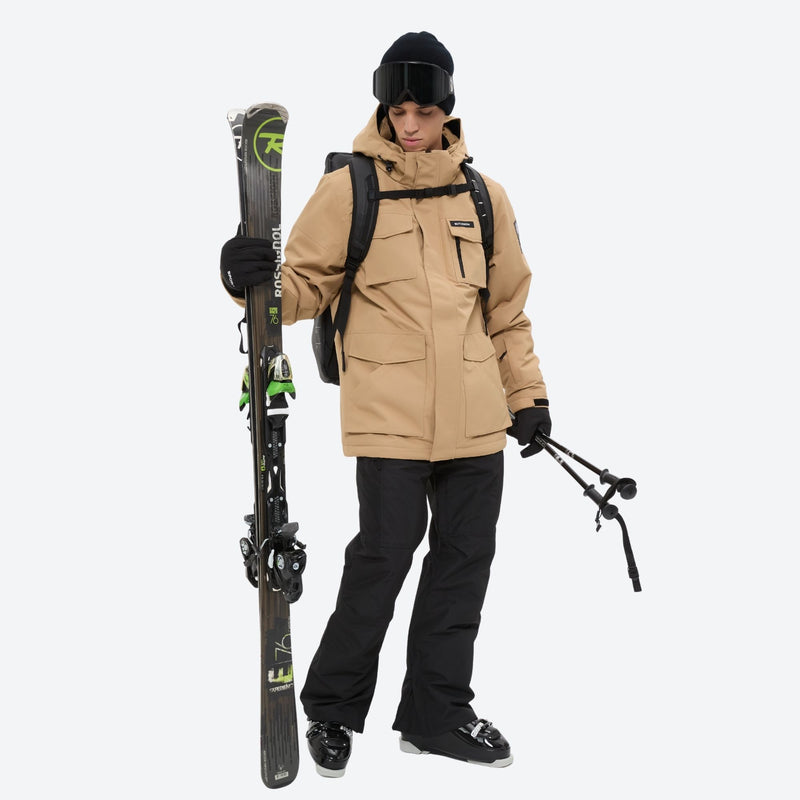 Men's breathable ski jacket with flap pockets - tan jacket with black pants, for resort and backcountry days