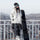All-mountain true twin snowboard - rider in white jacket, holding board at railing, for all-mountain snowboarding