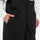 Unisex bib snowboard pants with snow gaiters - black, side pocket close-up with hand, for cold-weather winter sports