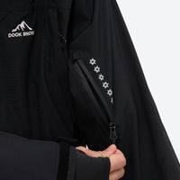 
                  
                    Men's waterproof 3L snow jacket and pants series - black, sleeve logo close-up detail, for resort and backcountry days
                  
                