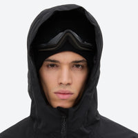 
                  
                    Men's breathable ski jacket and pants set - black, hood and face close-up with goggles, for powder and piste riding
                  
                