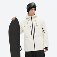 
                  
                    Men's waterproof 3L snow jacket and pants series - cream, on-model front with upright snowboard, for powder and piste riding
                  
                