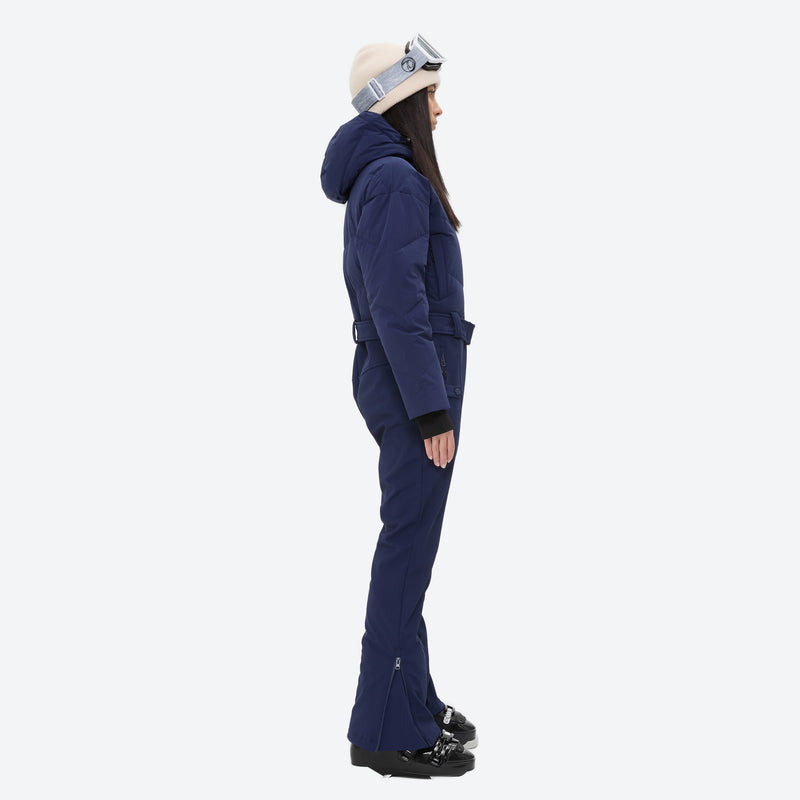 Women's breathable 3-layer jumpsuit ski suit - navy one-piece snow suit, on-model side view, for cold-weather winter sports