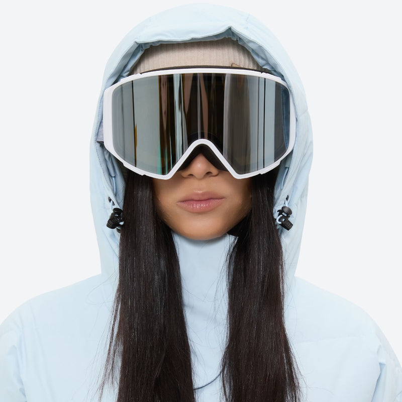 Women's breathable 3-layer jumpsuit ski suit - ice blue, hood and face close-up with goggles, for resort and backcountry days