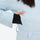 Women's waterproof 3L one-piece snow suit - ice blue, cuff inner thumbhole close-up with hand, for cold-weather winter sports