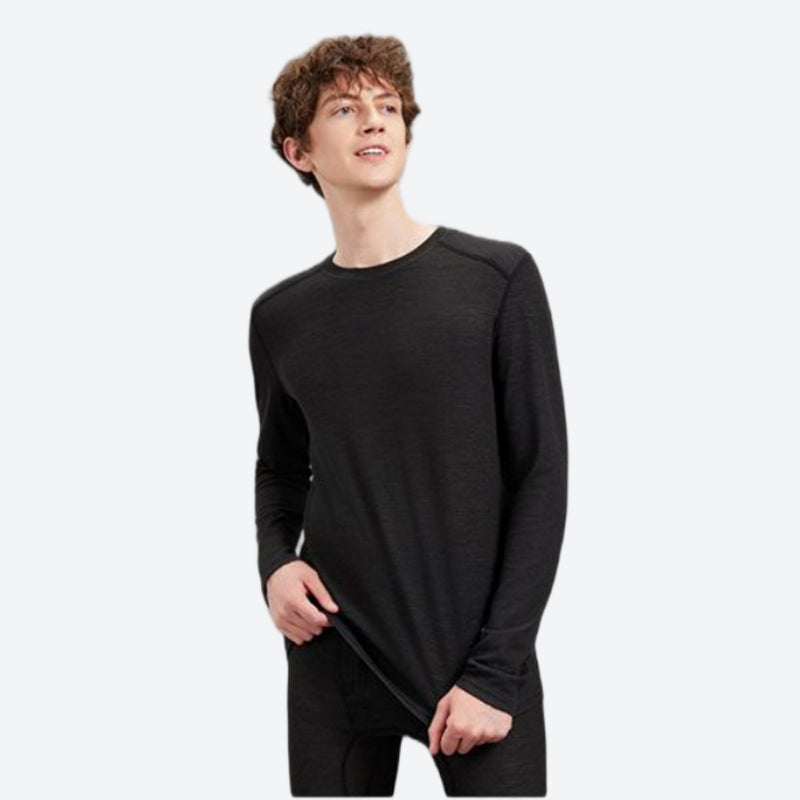 Warm merino wool baselayer suit for snow sports - black merino compression base layer suit on men, front standing view