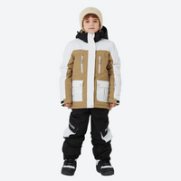 
                  
                    Kids breathable 2-layer ski suit with gaiters - tan white colorblock kids jacket with black pants, on-model front view
                  
                