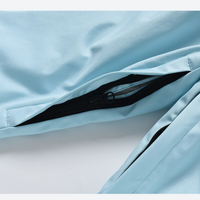 
                  
                    Kids waterproof 2L snow jacket and pants set - ice blue, pocket zip close-up detail, for snow play and winter commute
                  
                