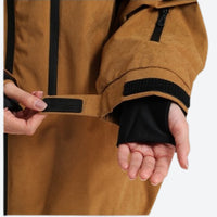 
                  
                    Unisex snowboard jacket and pants set - coffee brown, cuff strap close-up with hand, for skiing and snowboarding
                  
                