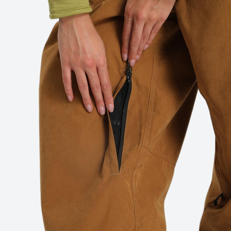 Unisex snowboard jacket and pants set - coffee brown, thigh zip vent close-up with hand, for powder days and winter commute