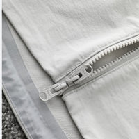 
                  
                    Men's breathable water-repellent softshell shell - white, zip puller close-up detail, for camping and outdoor wear
                  
                