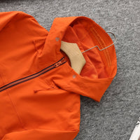 
                  
                    Women's light water-repellent hiking jacket - orange softshell jacket, flat lay hood close-up, for hiking and trekking
                  
                