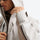 Unisex waterproof jacket with cape back vent - beige gray, collar close-up with hand, for resort and street wear