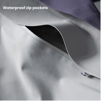 
                  
                    Unisex waterproof snowboard jacket with zip pockets - light gray, waterproof zip pocket close-up, for skiing and snowboarding
                  
                