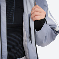 
                  
                    Men's 3-layer snowboard jacket and pants - light gray gradient, chest zip close-up with hand, for powder and piste riding
                  
                