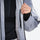Men's 3-layer snowboard jacket and pants - light gray gradient, chest zip close-up with hand, for powder and piste riding