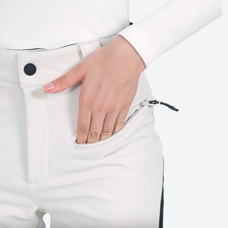 Women's slim waterproof ski trousers for resort - cream ski pants, waist pocket hand close-up, for snow sports weekends