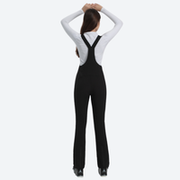 
                  
                    Women's slim fit waterproof ski bib pants - black slim fit ski bib, back view with hands at head, for snow sports weekends
                  
                