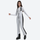 Women's stretchable ski bib with adjustable suspenders - white slim fit ski bib with black side stripe, walking side view