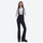 Women's slim fit waterproof ski bib pants - navy slim fit ski bib, front standing view, for winter mountain trips