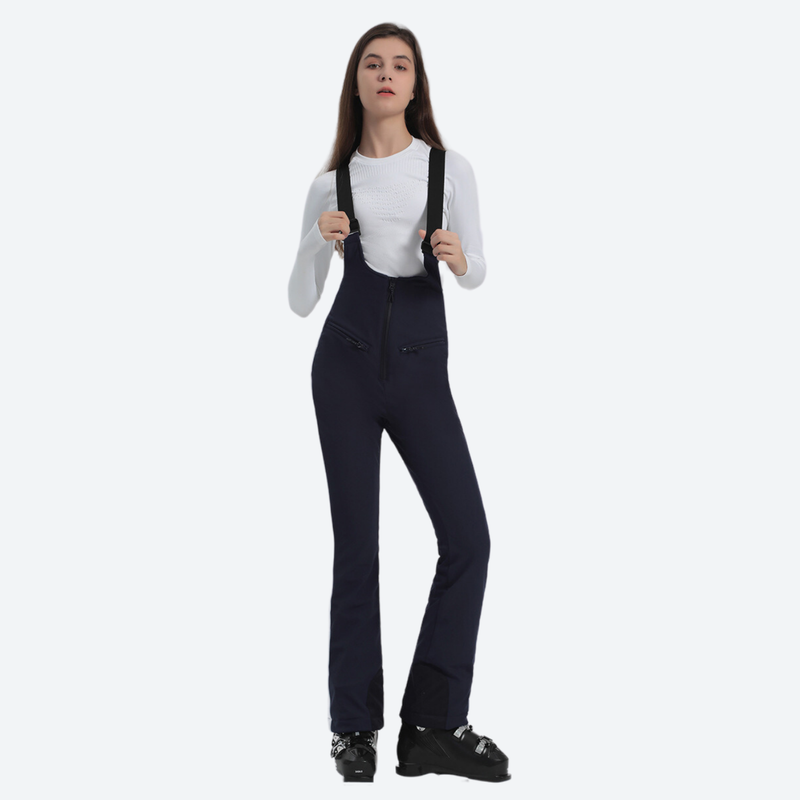 Women's slim fit waterproof ski bib pants - navy slim fit ski bib, front standing view, for winter mountain trips