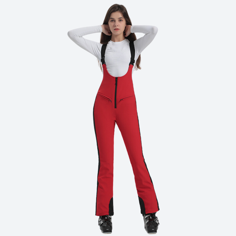 Flash sale waterproof ski bottoms - red ski bib on women, front view with hands at head, for winter mountain trips