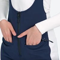 
                  
                    Women's slim fit waterproof ski bib pants - navy slim fit ski bib, waist pocket both hands close-up, for snow sports weekends
                  
                