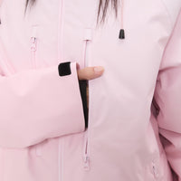 
                  
                    Women's 3-layer snowboard jacket and pants - light pink, chest zip close-up with hand, for cold-weather winter sports
                  
                