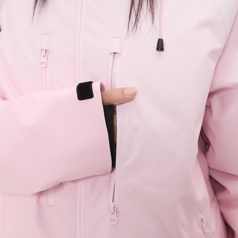 Women's 3-layer snowboard jacket and pants - light pink, chest zip close-up with hand, for cold-weather winter sports