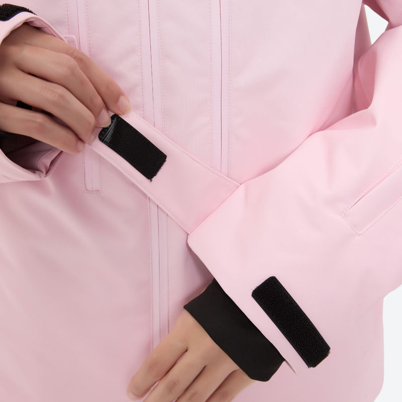 Women's 3-layer snowboard jacket and pants - light pink, cuff strap close-up with hand, for resort and backcountry days