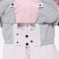 
                  
                    Women's 3-layer snowboard jacket and pants - light pink, inner snow skirt close-up detail, inner snow skirt blocks wind
                  
                