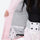 Women's 3-layer snowboard jacket and pants - light pink, interior lining close-up with hand, for powder and piste riding