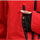 Men's adjustable ski pants with suspenders - red, chest zip close-up with hand, for deep powder winter days