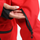 Insulated bib snow pants for men - red, cuff zip close-up with hand, for cold-weather winter sports