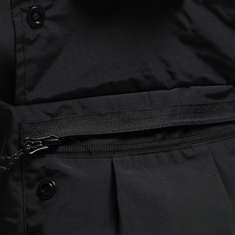 Men's adjustable snowboard cargo pants with gaiters - black, pocket zip close-up detail, for skiing and snowboarding