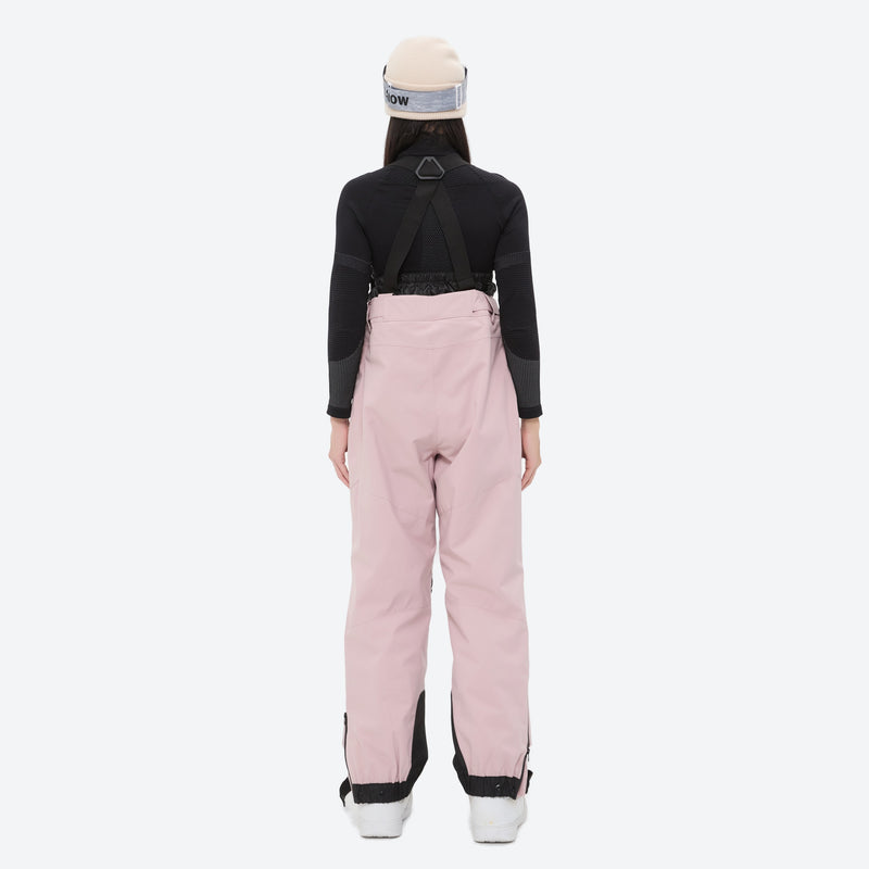 Insulated bib snow pants for women - pink bib pants, on-model back view, for deep powder winter days