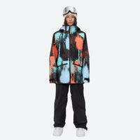 
                  
                    Women's 3L waterproof suspender snow pants - orange and blue abstract print jacket with black pants, on-model front view
                  
                