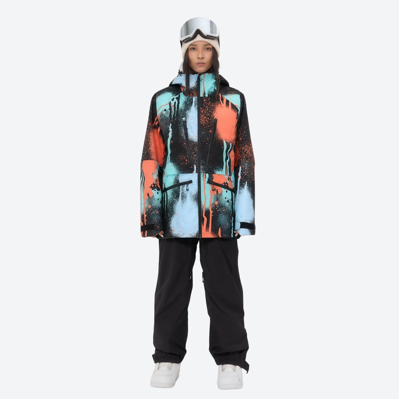 Women's 3L waterproof suspender snow pants - orange and blue abstract print jacket with black pants, on-model front view